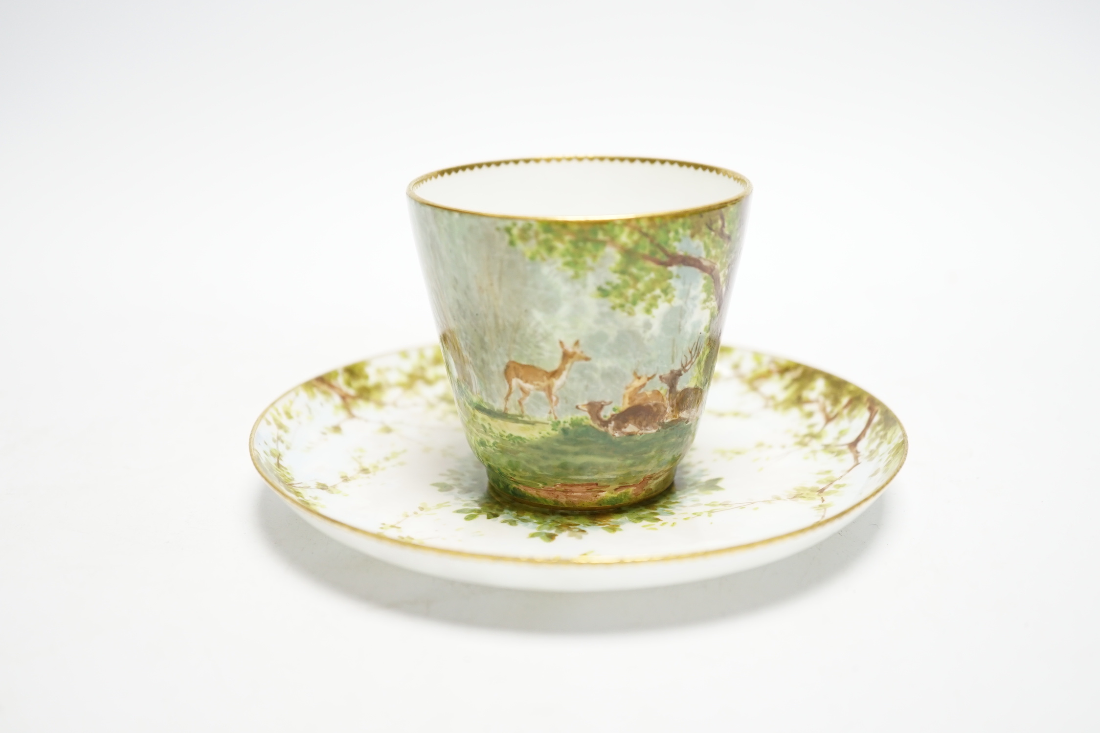 A Minton porcelain cup and saucer, painted with deer by Edouard Rischgitz